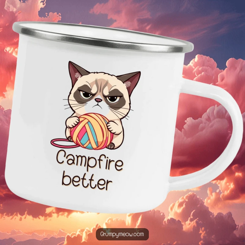 Funny grumpy cat with narrowed eyes, judging a brightly colored ball of yarn on a camping mug, for outdoor adventures, a funny gift.