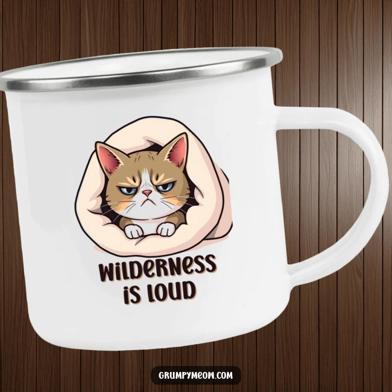Funny grumpy cat camping mug, peeking from under a blanket with a frown, for cozy outdoor relaxation.