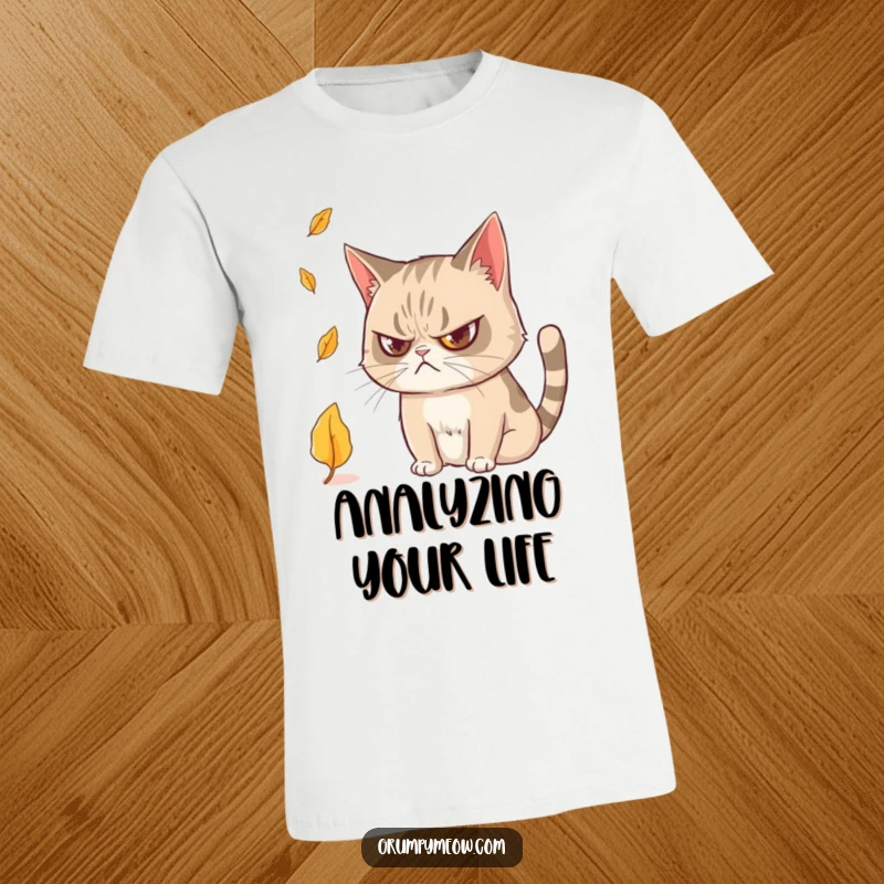 Funny Grumpy Cat T-Shirt: Features a grumpy feline captivated by a falling leaf, showcasing subtle curiosity.
