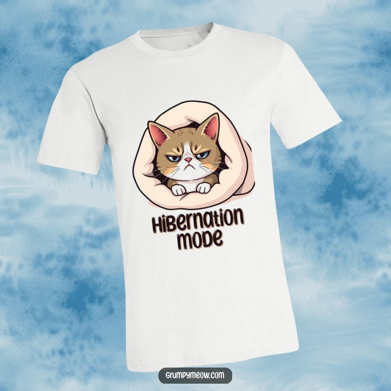 Funny grumpy cat t-shirt, emerging from under a blanket with a distinct frown, perfect for cozy, anti-social days.
